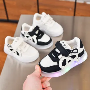 Detail of toddler light-up sneakers featuring panda pattern and glowing LED rubber soles