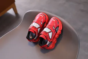 Detail view of red racing car-themed sneakers for kids with Shock Light velcro closure