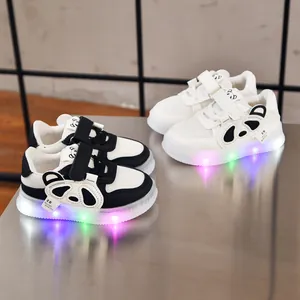 Detail of LED light-up soles on toddler sneakers with cute panda design and velcro strap