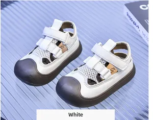 Close-up of white breathable hollow mesh kids' sandals with double hook-and-loop straps
