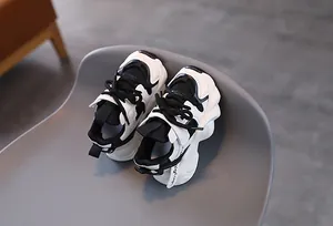 Close-up of black and white panda color kids athletic shoes with breathable mesh and thick soles