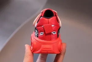 Detail of red leather toddler shoe heel with race car style embossed sole design