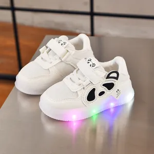 Detail of baby LED light-up sneakers with panda motif and multi-color glowing soles