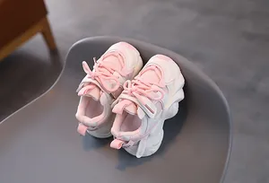 Detailed top view of pink kids sports shoes featuring mesh texture and soft soles