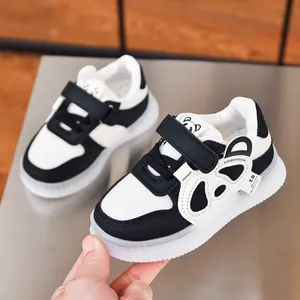 Detailed view of kids' cartoon bear sneakers with LED soles and mesh breathable upper