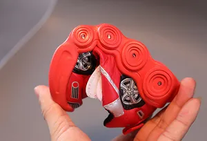Detail showing high flexibility and soft foldable rubber sole of red kids sneakers