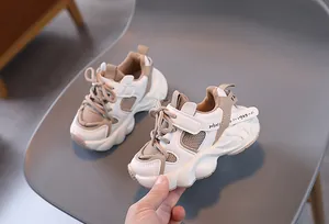 Detail of kids chunky sneakers featuring mesh leather upper and Velcro strap closure
