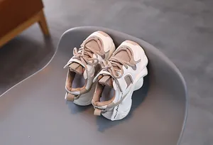 Detail view of children's warm sports sneakers showing breathable mesh and suede layers