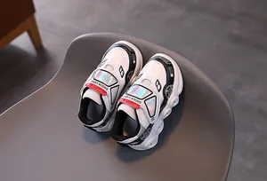 Detail of cartoon car design and Velcro closure on kids' non-slip light-up sneakers