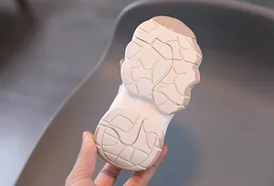 Close-up of non-slip rubber sole with size 23 marking for kids warm sneakers