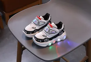 Detail of LED light-up racing car style kids sneaker with colorful flashing soles