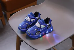 Close-up of blue racing-style kids sneakers with colorful LED lights on the soles
