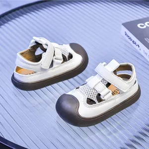 Detail of white mesh toddler sandals with protective rubber toe cap and velcro strap