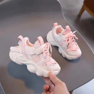 Pink and white children's warm sports sneakers with cozy lining and velcro straps
