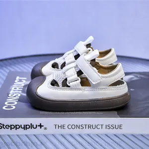 Detail view of children's mesh sandals with velcro closure and protective brown toe caps