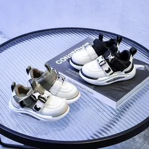 Kids leather sneakers with dual buckle closure and visible air cushion sole in two colors