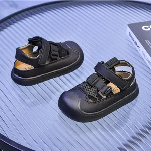 Detail view of black kids sports sandals featuring breathable mesh and velcro closures