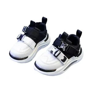 Kids black and white leather sneakers with double buckle straps and soft chunky soles