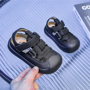 Detail view of black kids beach sandals with mesh fabric, toe protection and velcro straps