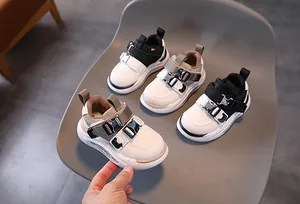 Detailed view of kids' chunky functional sneakers with dual metal buckle closure system
