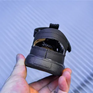 Detail of black kids mesh sandals featuring velcro closure and non-slip thick rubber sole