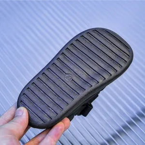 Close-up of non-slip rubber sole with size 23 marking on kids hollow beach sandals