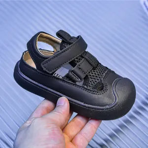 Detail view of black hollow mesh toddler sandals with hook-and-loop straps and anti-collision toe