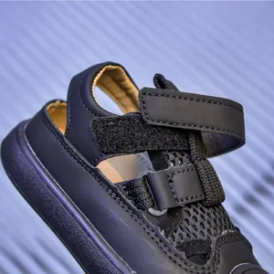 Detail of black children's sandals featuring breathable mesh and adjustable velcro straps