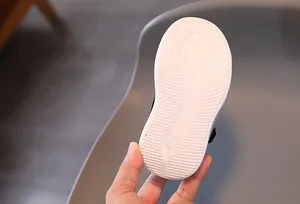 Close-up of white anti-slip outsole with size 21 marking for kids' sneakers