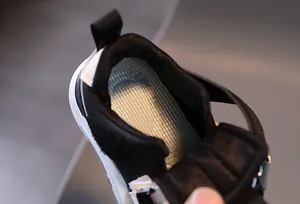 Detail of breathable mesh insole and soft padded collar on children sneaker