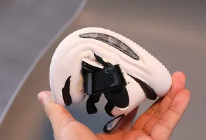 Flexible rubber sole of children's sneakers showing extreme bending and durability