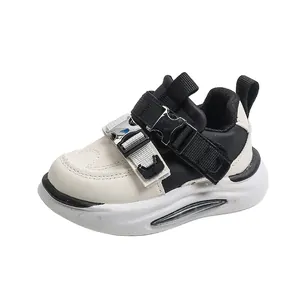 Kids black and white leather sneakers with LED glowing soles and adjustable straps