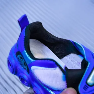 Gros plan de baskets LED bleu et noir pour enfants avec doublure en mesh et style course