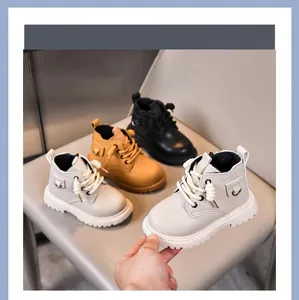 Three pairs of classic children's winter boots in beige, yellow, and black colors