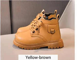 Detail view of children's yellow brown worker boots with side pocket decor and rubber sole