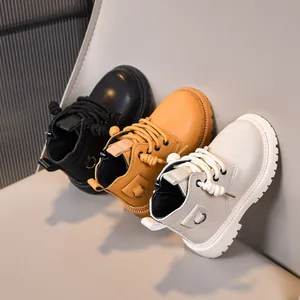 Detailed view of children's martin boots in black, yellow, and beige with side zippers