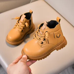 Close-up of kids' winter ankle boots featuring soft leather and side zipper detail