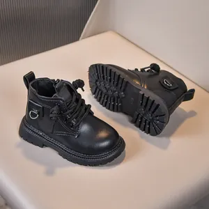 Detail of children's black matte leather boots featuring side zipper and thick rubber sole