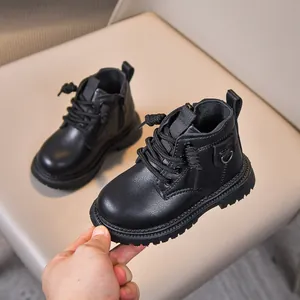 Close-up of children's black matte leather boots featuring side zipper and non-slip sole