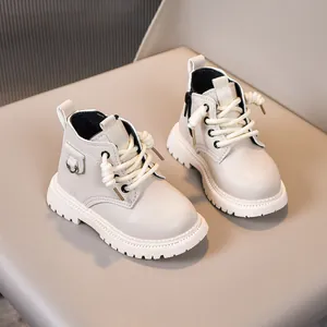 Close-up of beige kids Martin boots featuring side zipper and thick non-slip lug sole