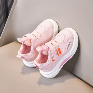 Detail of pink kids sneakers showing breathable mesh, velcro strap, and thick nonslip sole