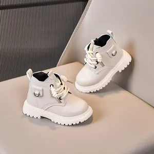 Close-up of kids cream leather Martin boots featuring side zipper and thick non-slip soles