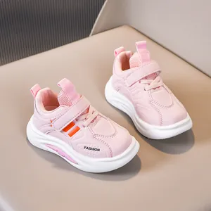 Detail of pink kids' sneakers with hook-and-loop closure and non-slip white rubber sole