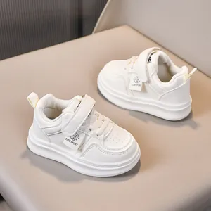 Detail of white kids sports shoes with velcro straps and breathable synthetic leather