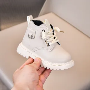 Detailed macro shot of cream faux leather kids boot with anti-slip thick rubber sole