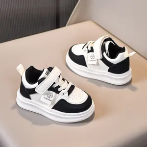Detail view of children's sneakers with velcro strap and breathable leather toe box