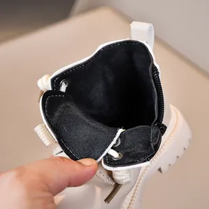 Detail view of children's beige Martin boots showing side zipper and mesh lining