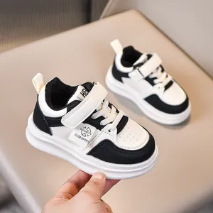 Detail of children's black and white leather sneakers with velcro and non-slip sole