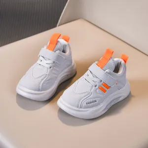 Close-up of children sneakers with velcro closure and mesh leather stitching detail
