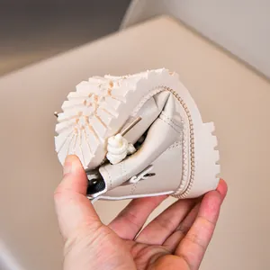 Close-up showing the flexible soft sole of cream-colored children's Martin boots